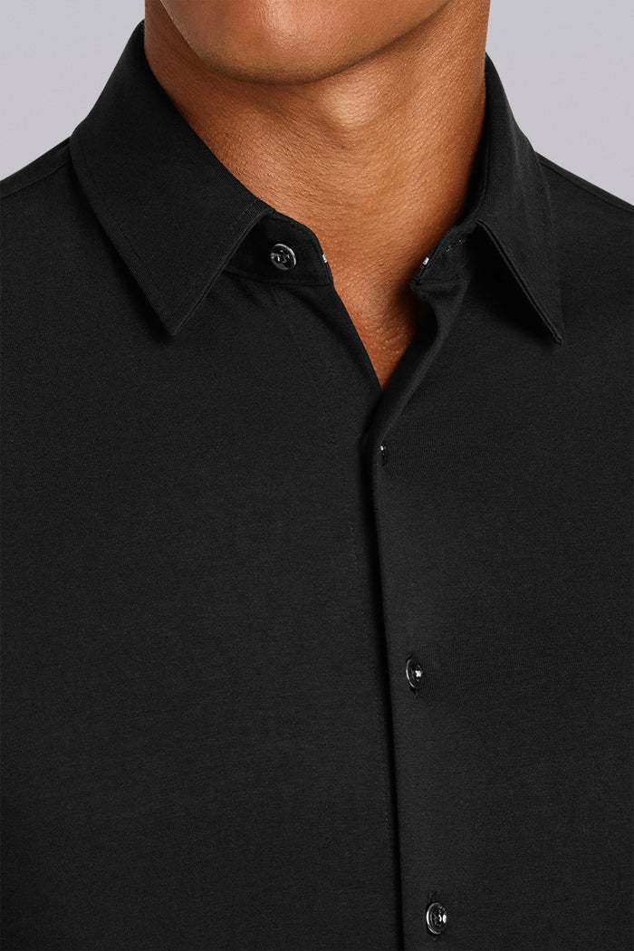 Model showcasing Tenacity Black and White long sleeve formal collar dress shirt.