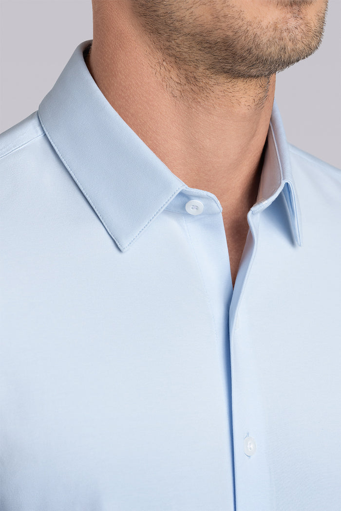 Model wearing Tenacity Classic Country Air Icy Cotton® long sleeve collar shirt, styled with navy pants.