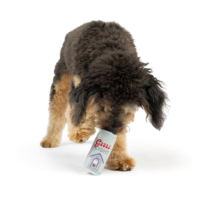 Dog with Tiny Tuff Grrrs Light on a white background.