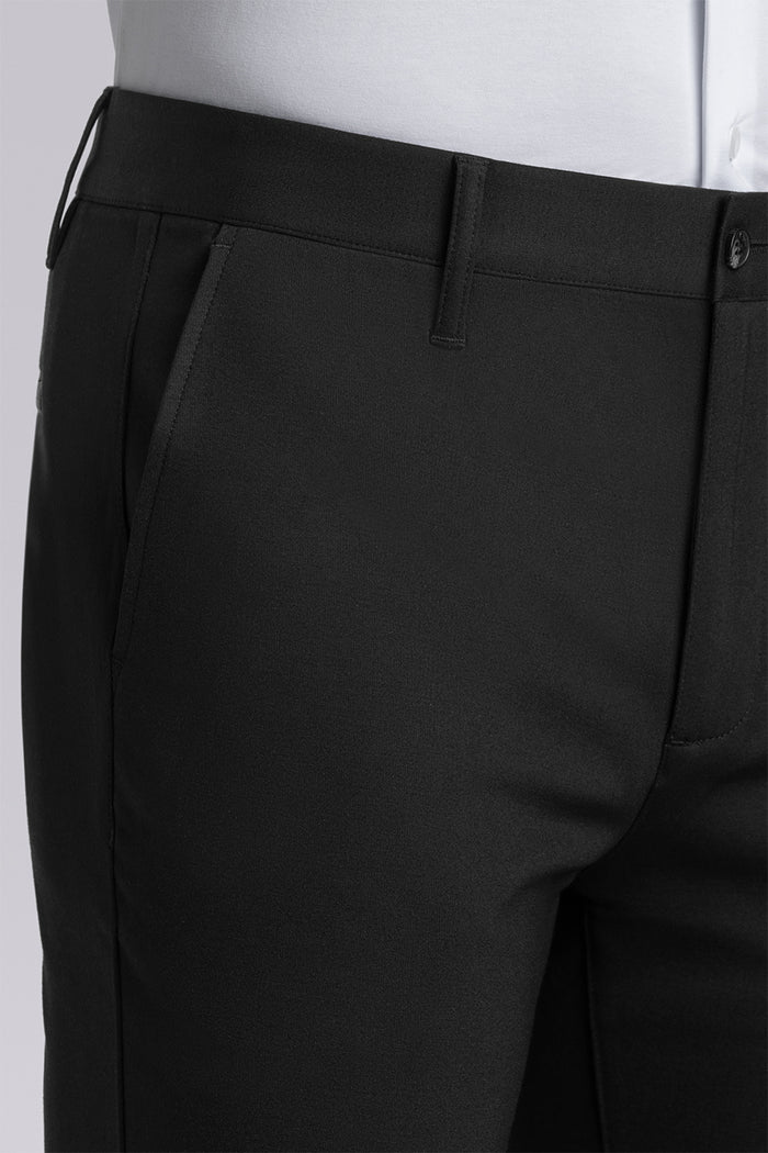 Model wearing Vigor Black Icy Knit mid rise pants, styled with white long sleeve shirt.