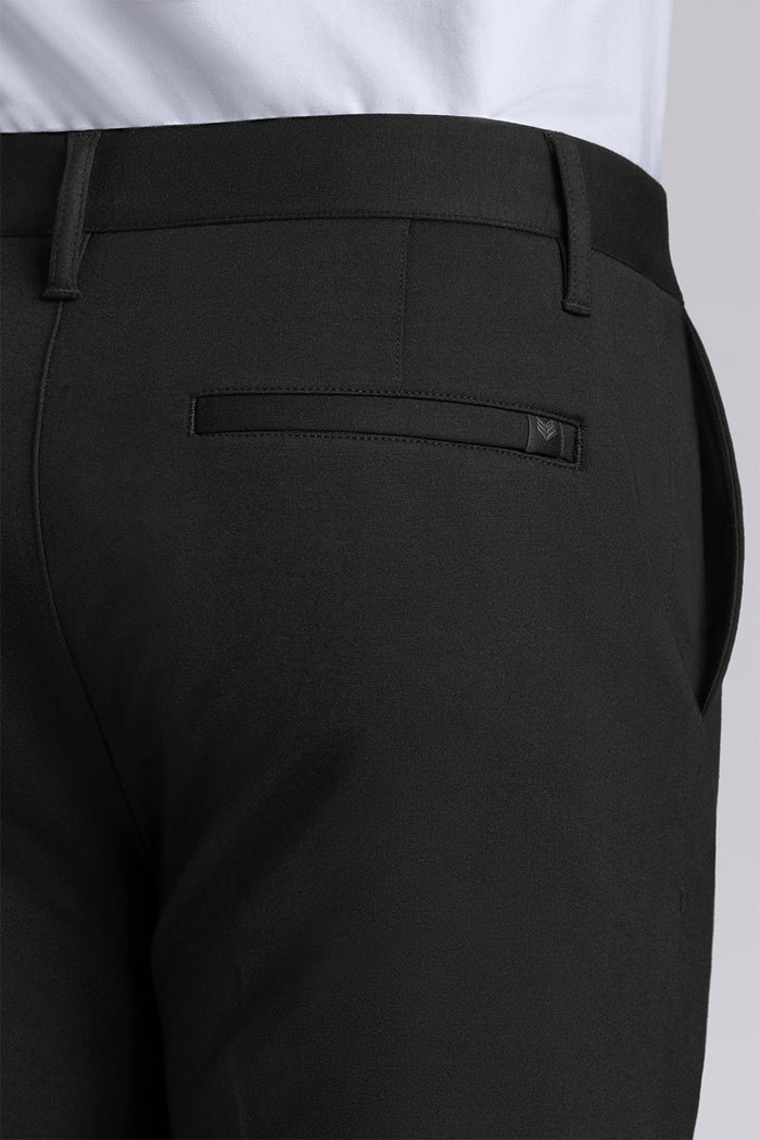 Model wearing Vigor Black Icy Knit mid rise pants, styled with white long sleeve shirt.