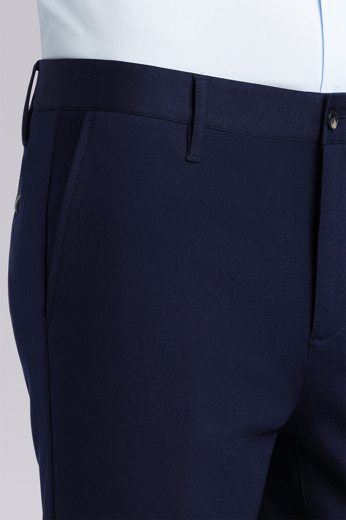 Model wearing Vigor Navy Icy Knit mid rise pants, styled with light blue long sleeve shirt.