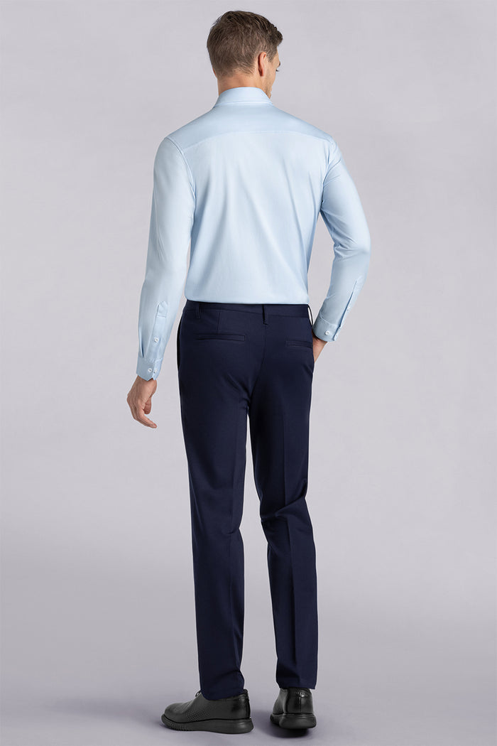 Model wearing Vigor Navy Icy Knit mid rise pants, styled with light blue long sleeve shirt.