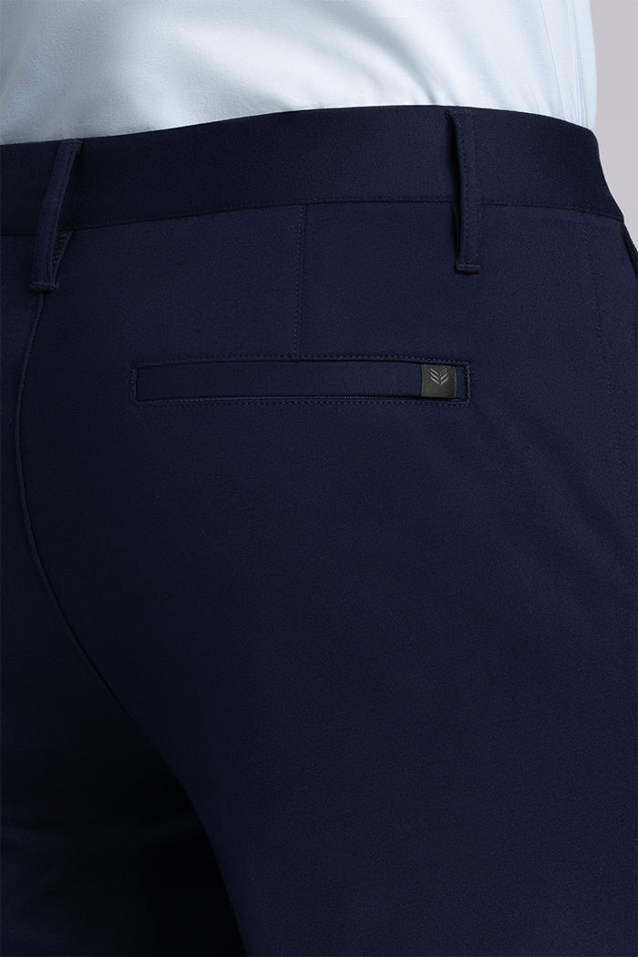 Model wearing Vigor Navy Icy Knit mid rise pants, styled with light blue long sleeve shirt.