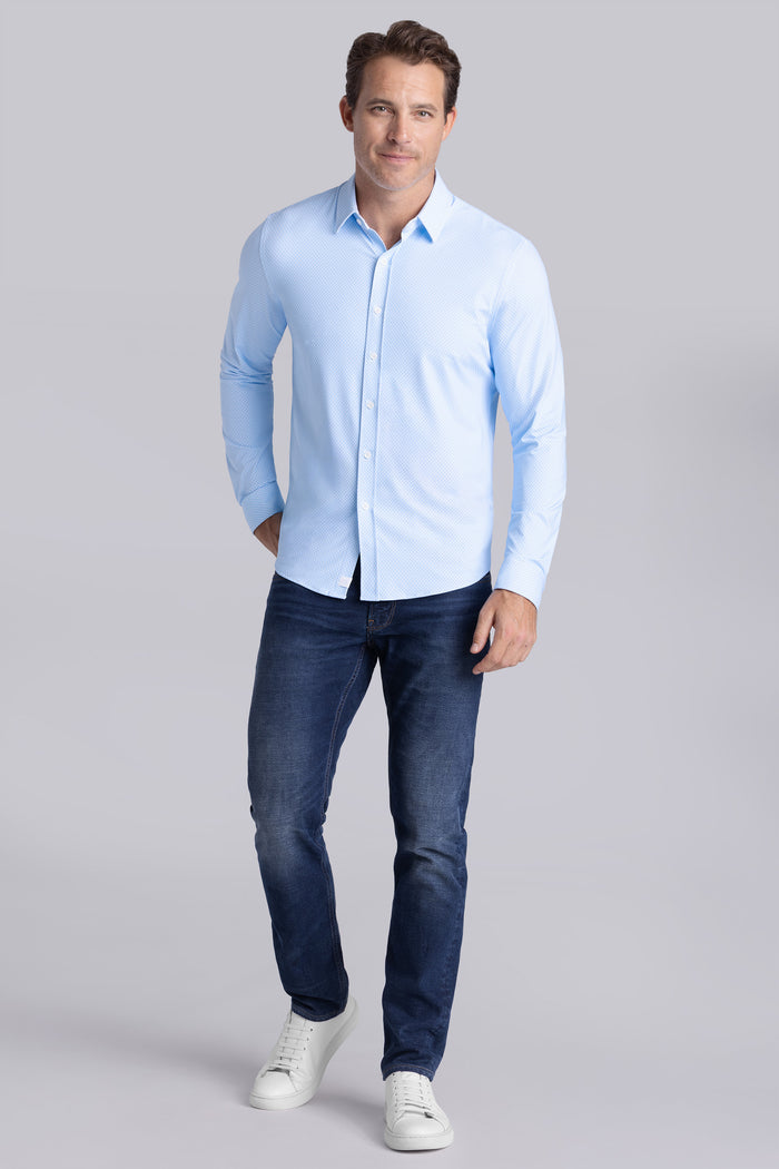Model wearing Wavelength Light Blue 6-WayKnit® long sleeve shirt classic collar, styled with navy pants.