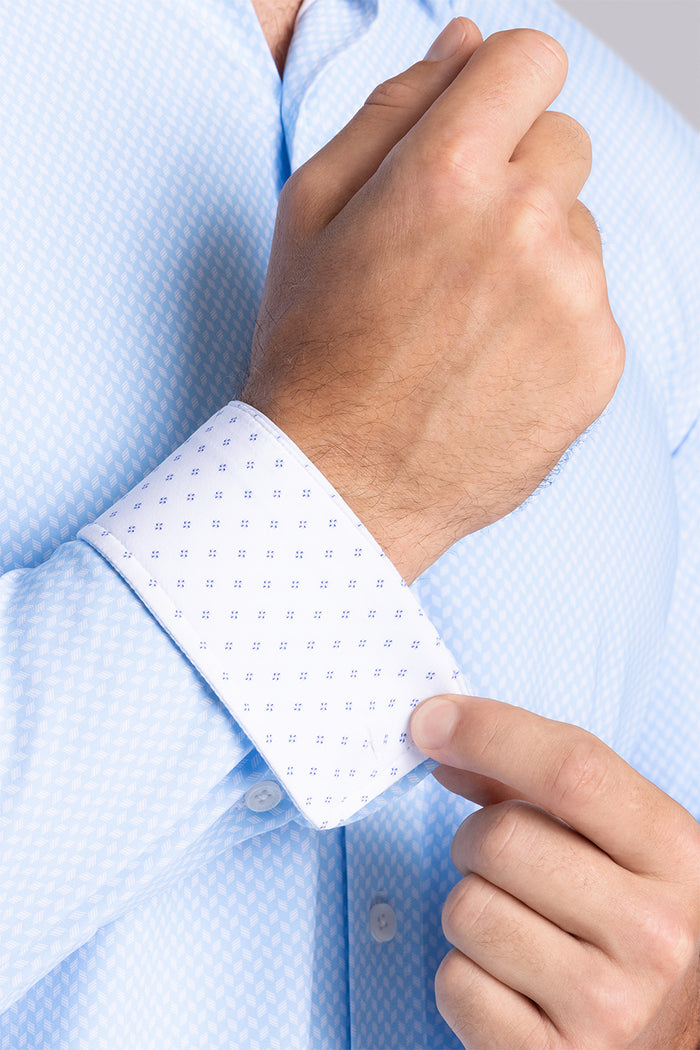Model wearing Wavelength Light Blue 6-WayKnit® long sleeve shirt classic collar, styled with navy pants.