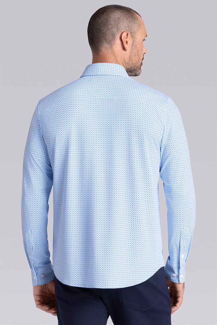 Model wearing Wavelength Ocean Blue 6-WayKnit® long sleeve shirt classic collar, styled with black pants.
