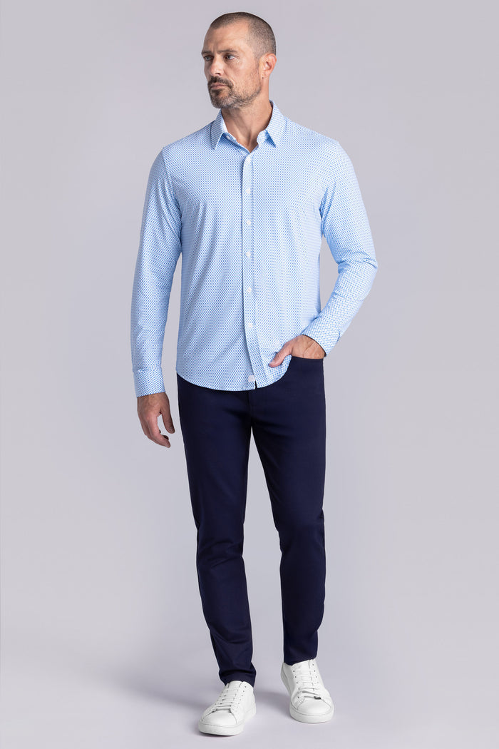 Model wearing Wavelength Ocean Blue 6-WayKnit® long sleeve shirt classic collar, styled with black pants.