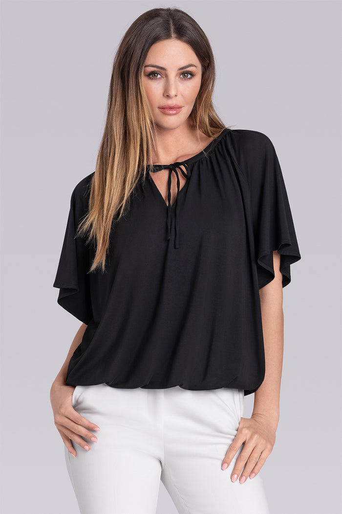 Model wearing Whisper Black Icy Bamboo® keyhole flutter sleeve tie-front, styled with white pants.