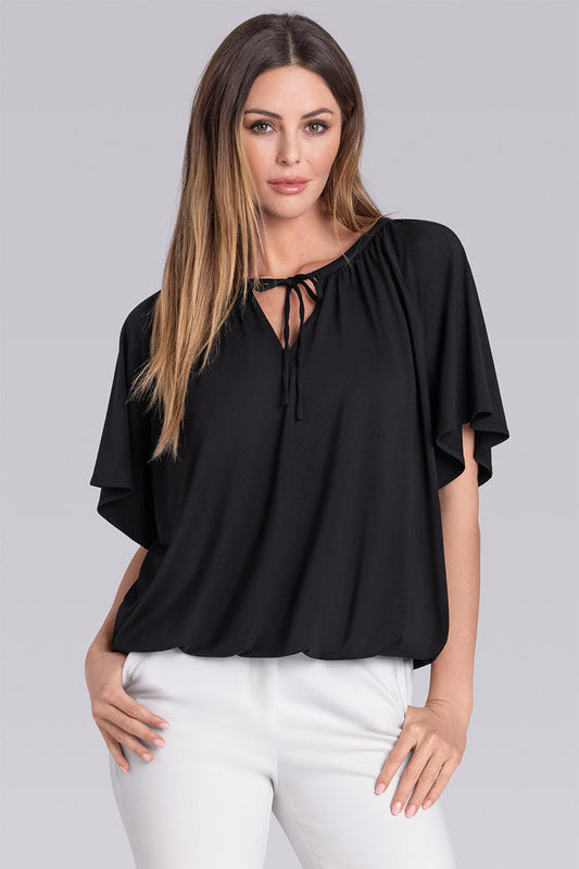 Model wearing Whisper Black Icy Bamboo® keyhole flutter sleeve tie-front, styled with white pants.