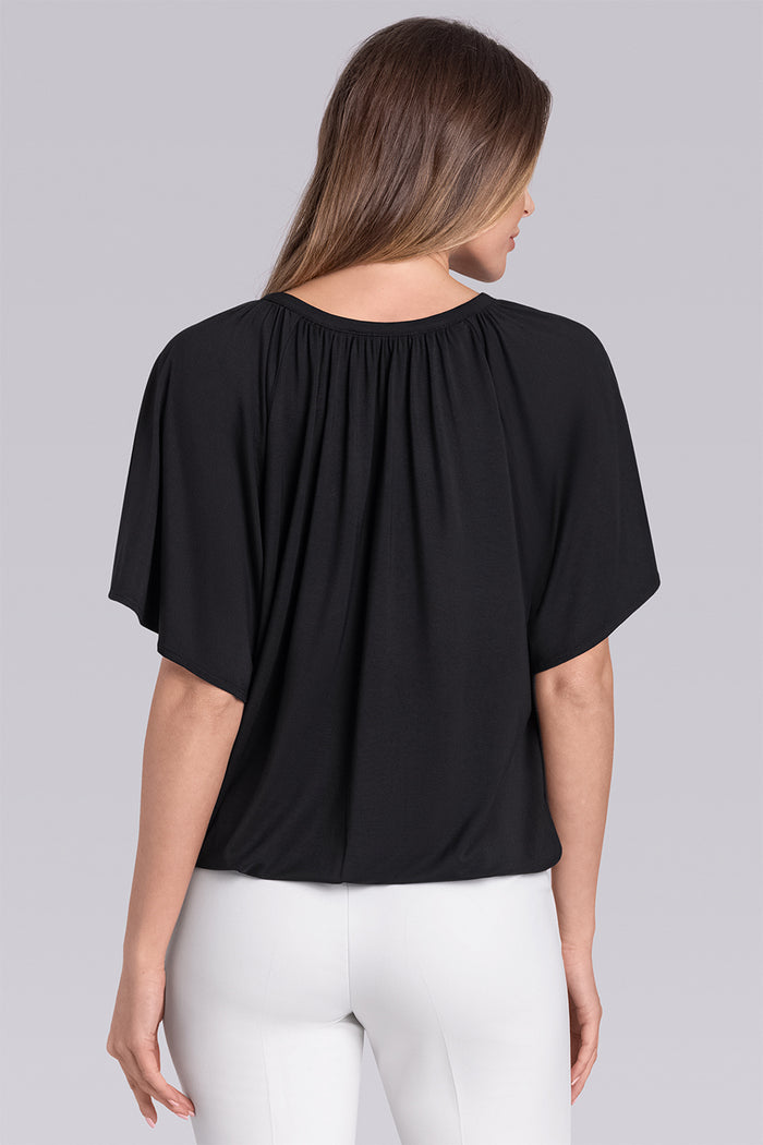 Model wearing Whisper Black Icy Bamboo® keyhole flutter sleeve tie-front, styled with white pants.
