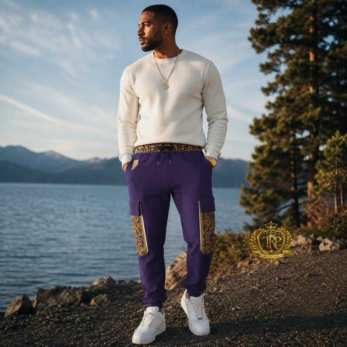 Front view of a man wearing purple Yahuah Yahusha lantern cargo joggers with patterned waist and gold trim side pockets.