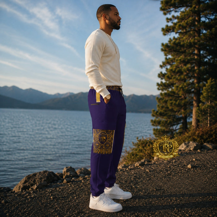 Right side profile view of a man styled in purple Yahuah Yahusha lantern cargo joggers with gold ornate pocket detailing.