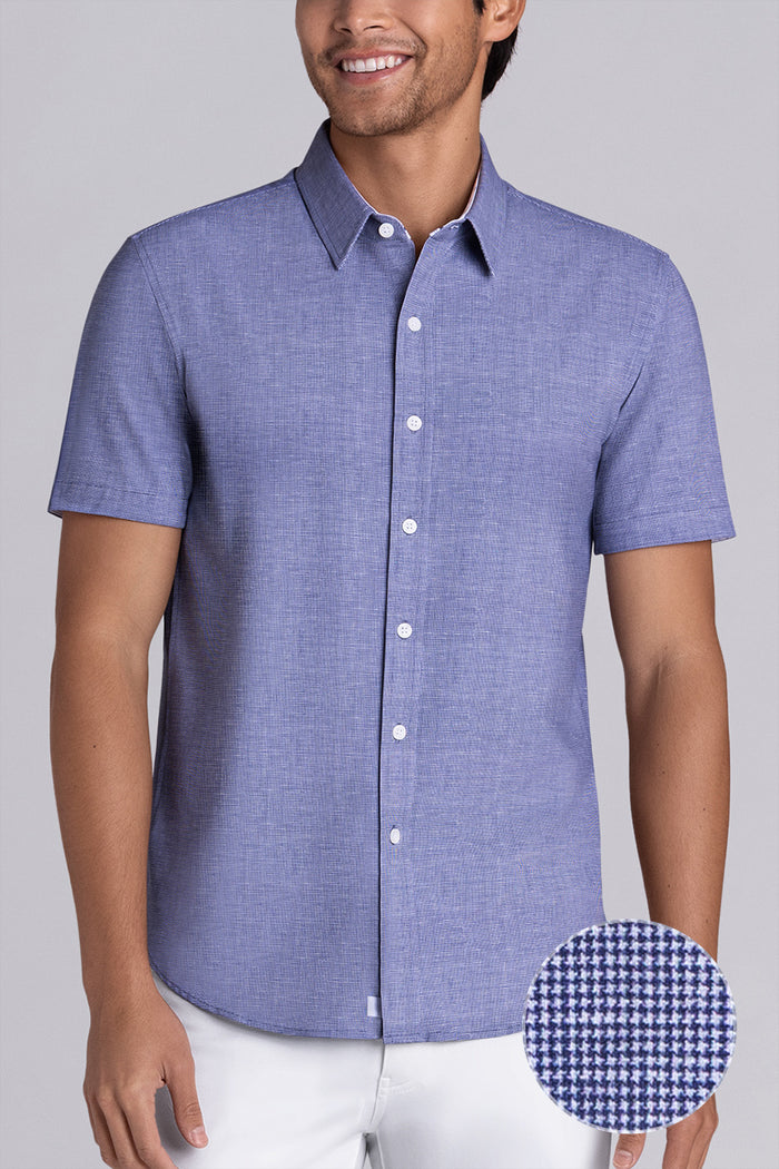 Model wearing Zest Navy short sleeve classic collar shirt, styled with white shorts.