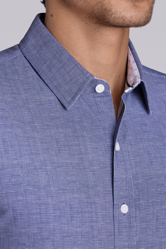 Model wearing Zest Navy short sleeve classic collar shirt, styled with white shorts.