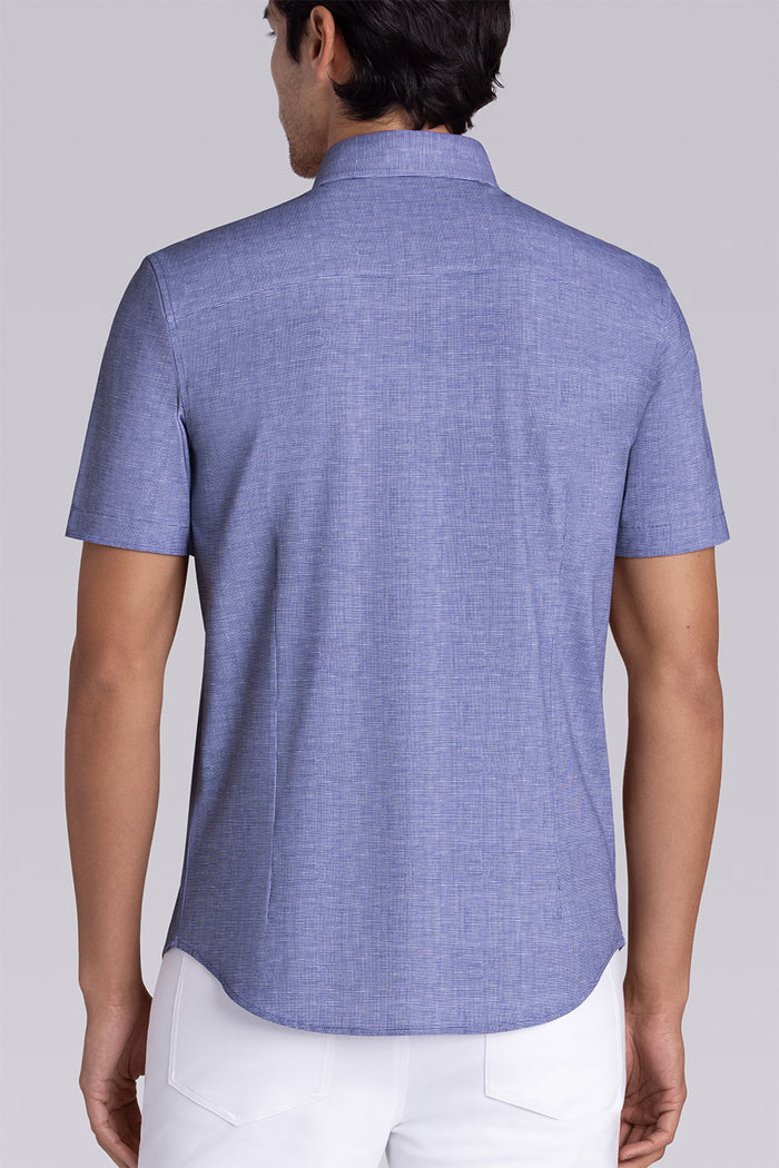 Model wearing Zest Navy short sleeve classic collar shirt, styled with white shorts.