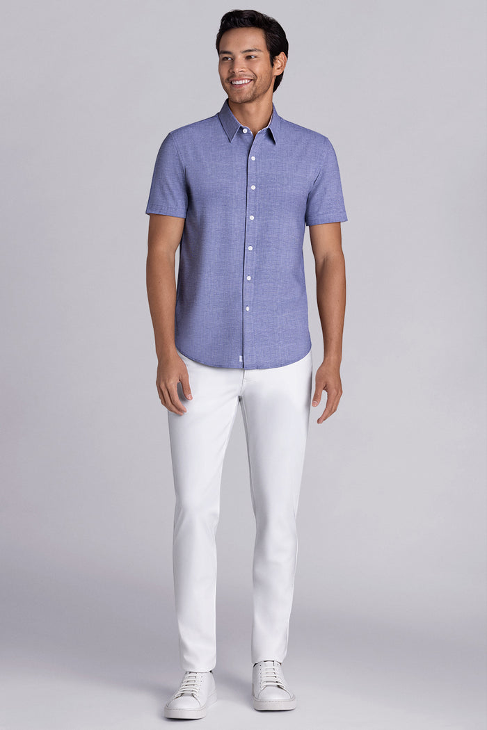 Model wearing Zest Navy short sleeve classic collar shirt, styled with white shorts.