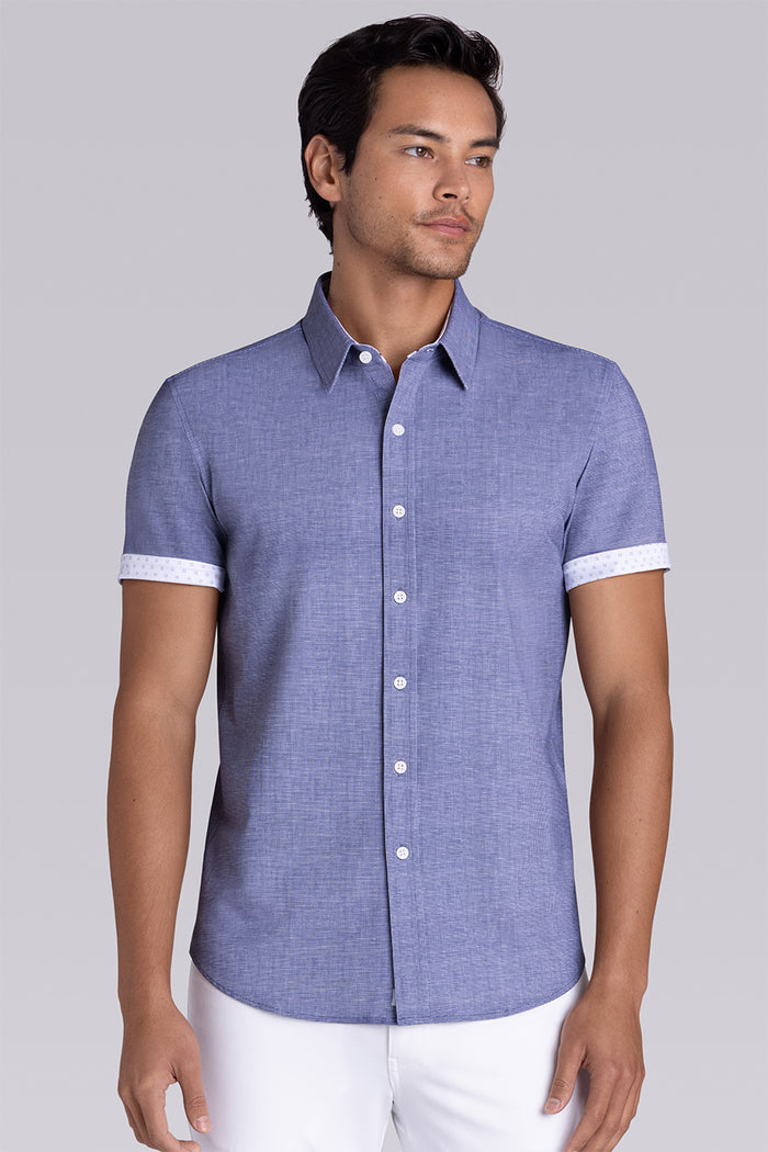 Model wearing Zest Navy short sleeve classic collar shirt, styled with white shorts.