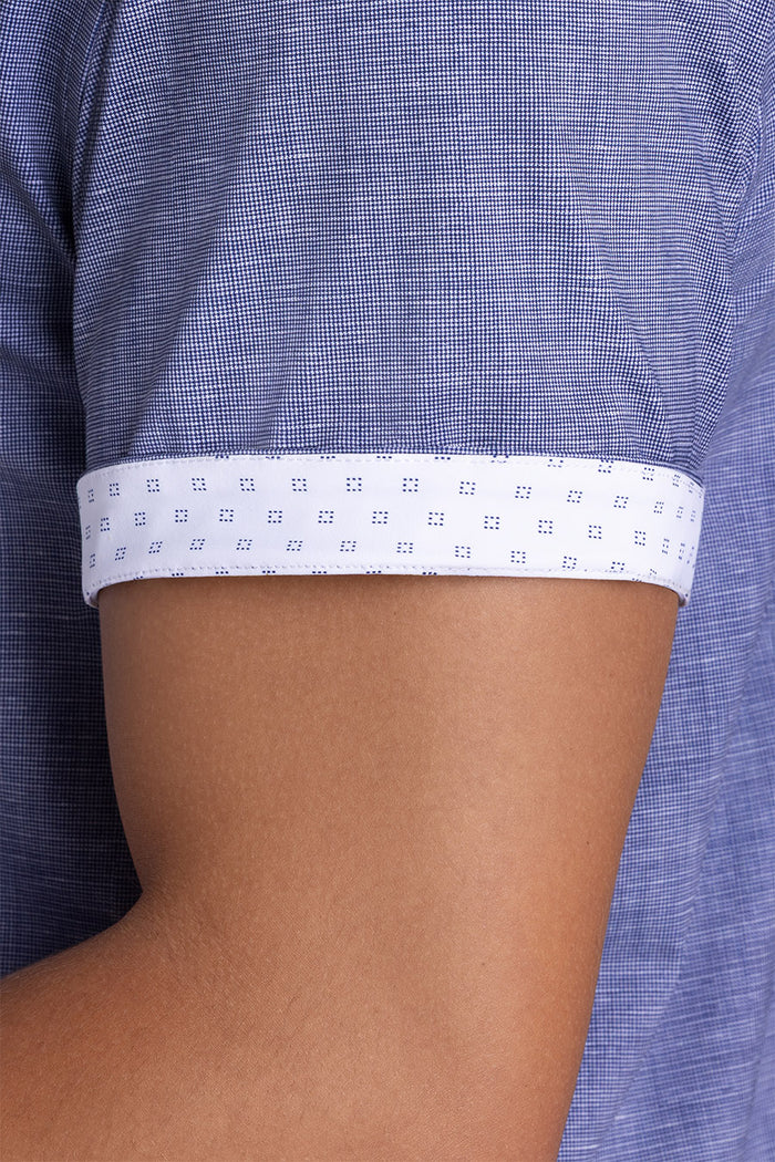 Model wearing Zest Navy short sleeve classic collar shirt, styled with white shorts.