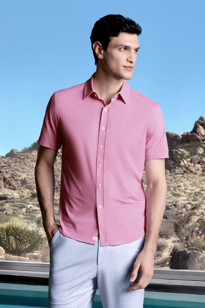 Model wearing Zest Raspberry short sleeve classic collar shirt, styled with white shorts.