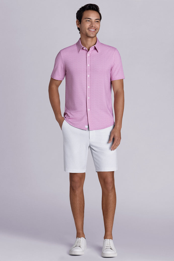 Model wearing Zest Raspberry short sleeve classic collar shirt, styled with white shorts.