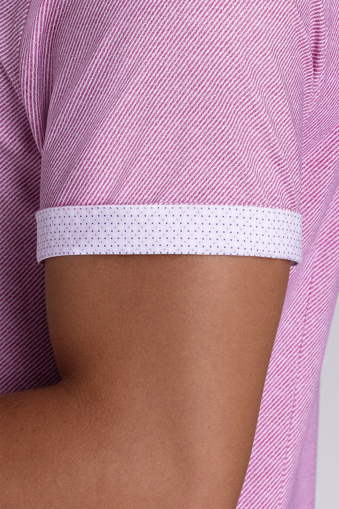 Model wearing Zest Raspberry short sleeve classic collar shirt, styled with white shorts.